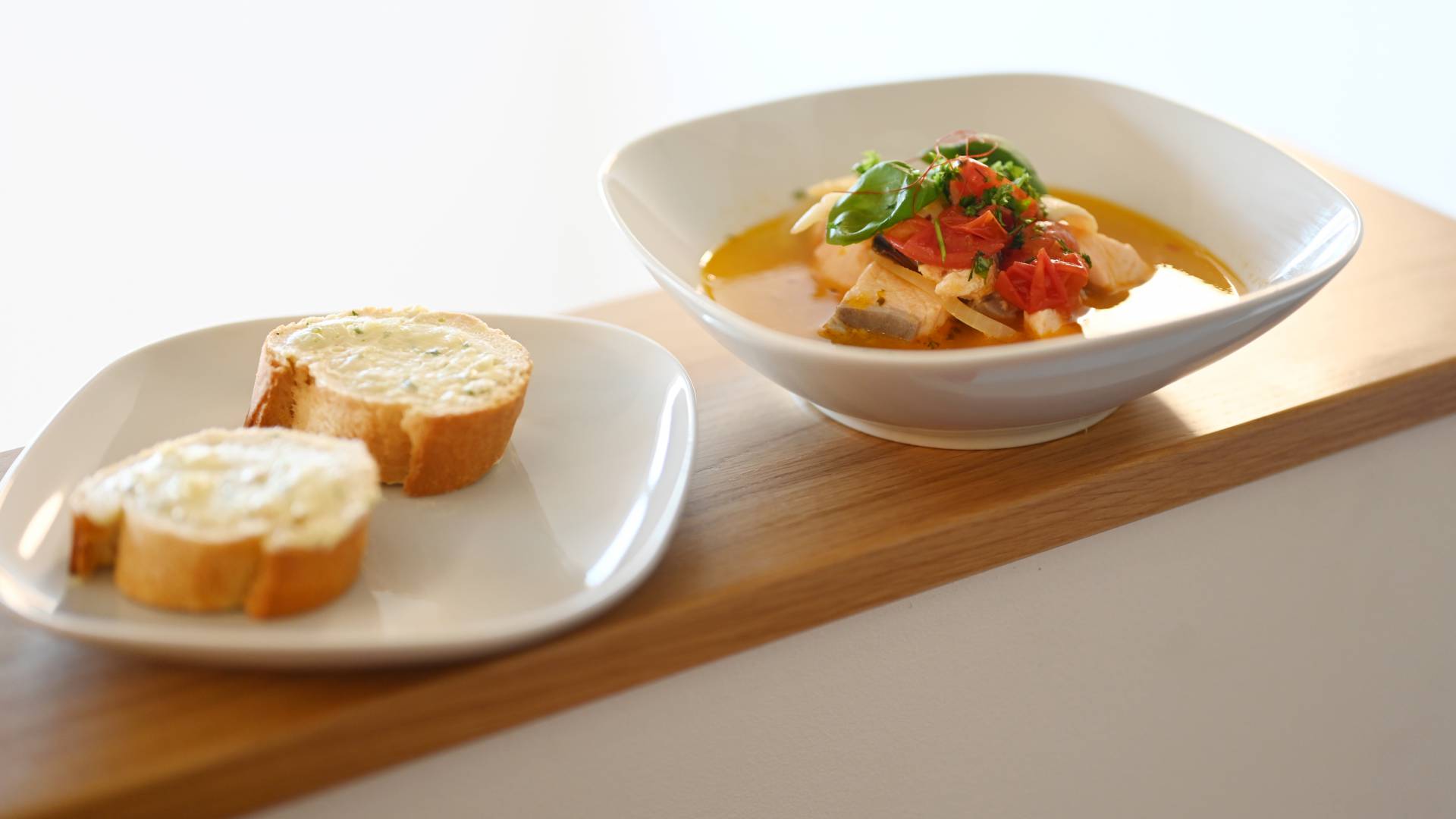 Suppe mit Fisch und Gemüseeinlage mit Baguette